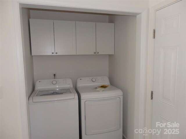 laundry area featuring independent washer and dryer and cabinet space