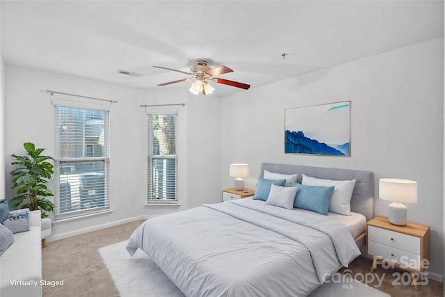 carpeted bedroom featuring baseboards and ceiling fan