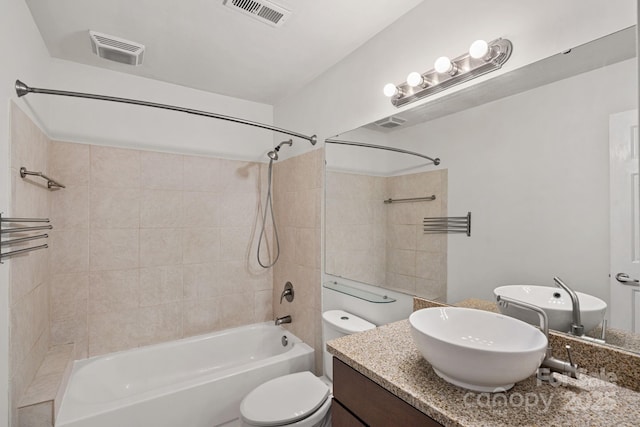 full bathroom with shower / tub combination, vanity, and toilet