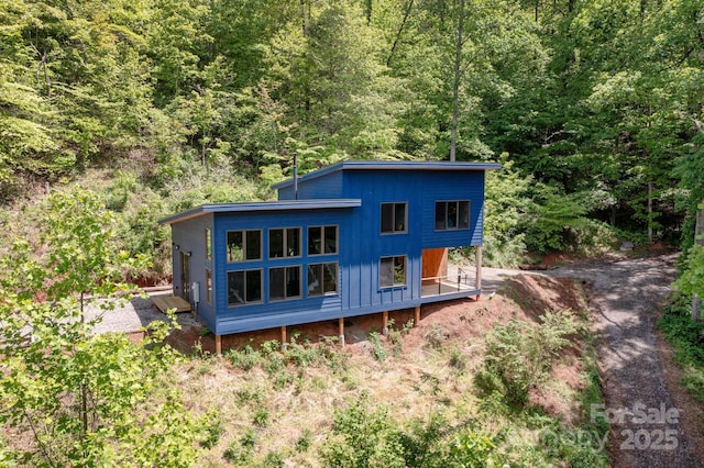 83 Mount Airy Rd, Marshall, NC 28753 - rear view of property featuring a wooded view and board and batten siding