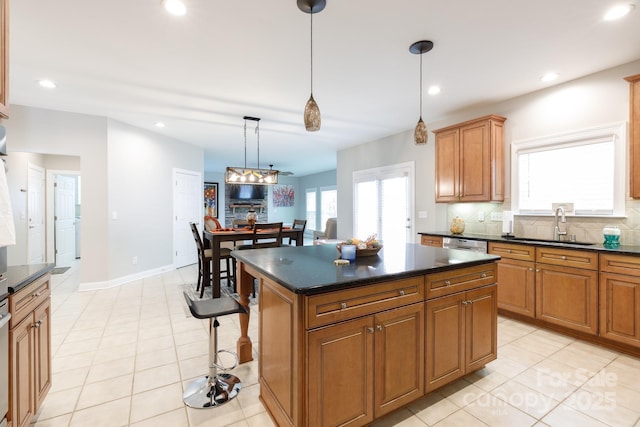kitchen featuring a sink, brown cabinetry, backsplash, and recessed lighting