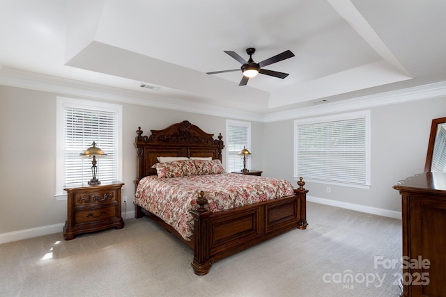 bedroom featuring light colored carpet, multiple windows, visible vents, and a raised ceiling