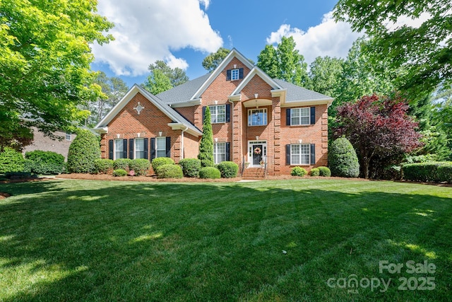 view of front of property with brick siding and a front yard
