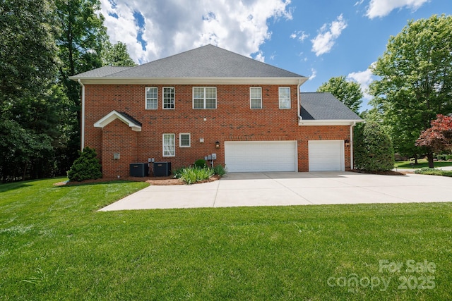 back of property featuring a yard, concrete driveway, cooling unit, and brick siding