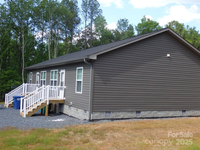 view of property exterior with crawl space