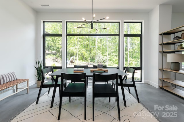 129 English Dr, Candler, NC 28715 - dining area featuring concrete flooring, a chandelier, and baseboards