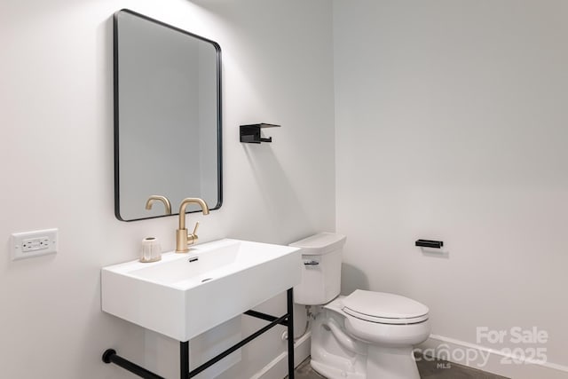 129 English Dr, Candler, NC 28715 - bathroom with toilet, baseboards, and a sink