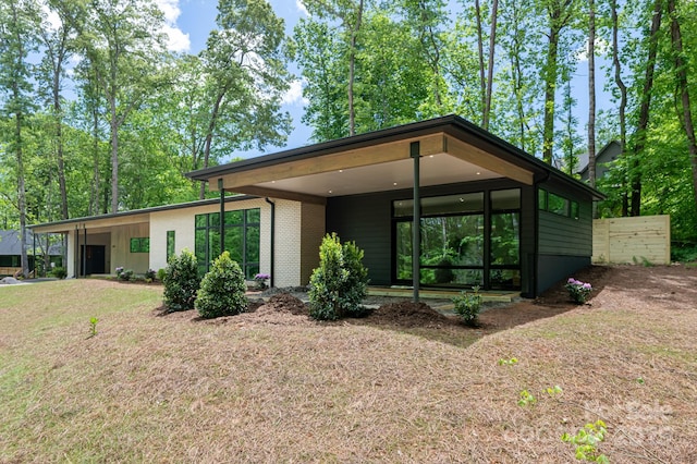 129 English Dr, Candler, NC 28715 - view of front of property with brick siding and a front yard