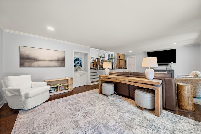 living room with ornamental molding, wood finished floors, recessed lighting, and baseboards
