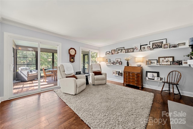 living room with ornamental molding, dark wood finished floors, and baseboards