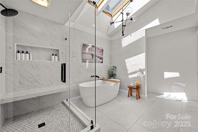 full bath with a skylight, a stall shower, and a freestanding tub