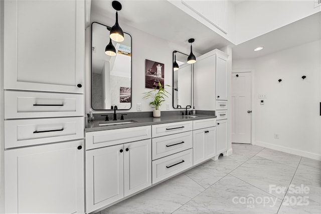 full bath with marble look tiles, double vanity, baseboards, and recessed lighting