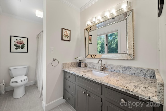 full bath with ornamental molding, vanity, toilet, and baseboards