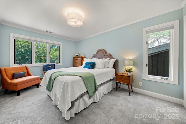 carpeted bedroom featuring ornamental molding, multiple windows, and baseboards