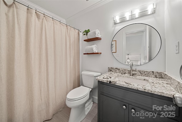 bathroom with crown molding, toilet, and vanity