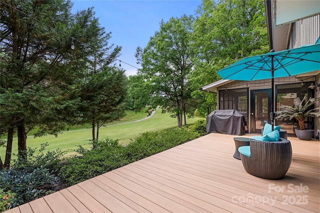 wooden terrace featuring grilling area, a lawn, and a sunroom