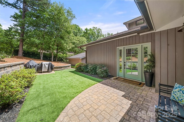 view of grassy yard with a patio