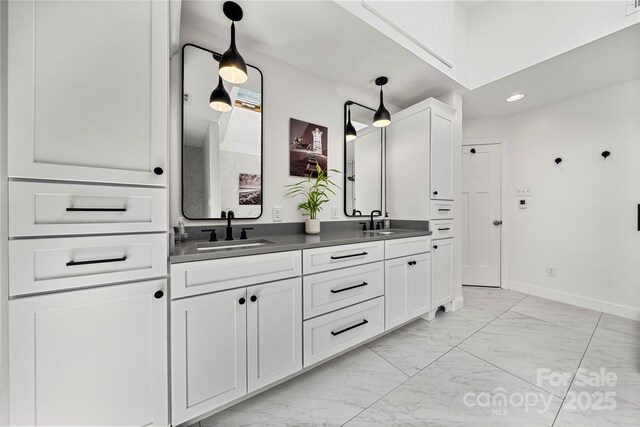 54 Honeysuckle Woods, Clover, SC 29710 - bathroom featuring marble look tile flooring, double vanity, baseboards, and recessed lighting