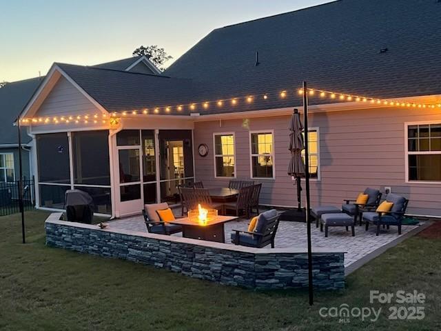 1360 Dali Blvd, Mount Holly, NC 28120 - rear view of property featuring a fire pit, a patio, a sunroom, and a lawn