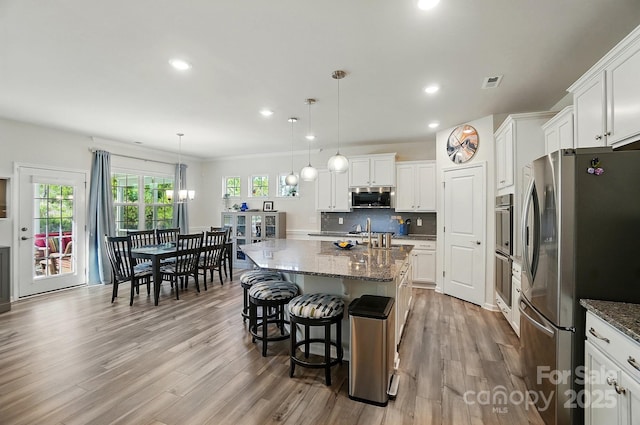 1360 Dali Blvd, Mount Holly, NC 28120 - kitchen with stainless steel appliances, dark stone countertops, light wood finished floors, and recessed lighting