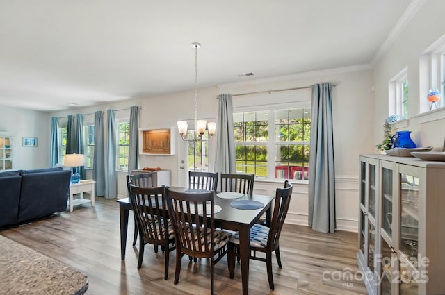 1360 Dali Blvd, Mount Holly, NC 28120 - dining space with a chandelier, healthy amount of natural light, wood finished floors, and crown molding