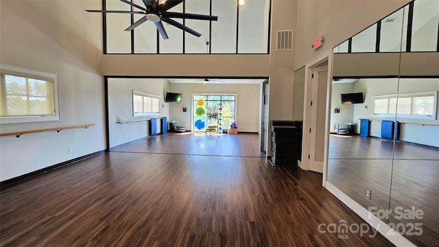 1360 Dali Blvd, Mount Holly, NC 28120 - unfurnished living room featuring ceiling fan, a towering ceiling, wood finished floors, and baseboards