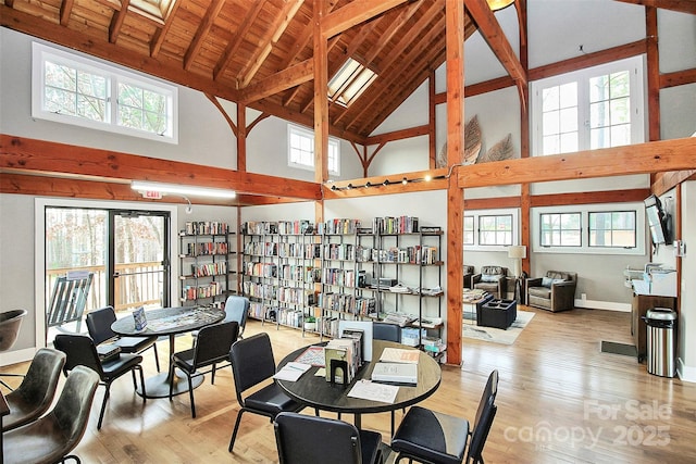 1360 Dali Blvd, Mount Holly, NC 28120 - dining room with high vaulted ceiling, wood finished floors, healthy amount of natural light, beamed ceiling, and baseboards