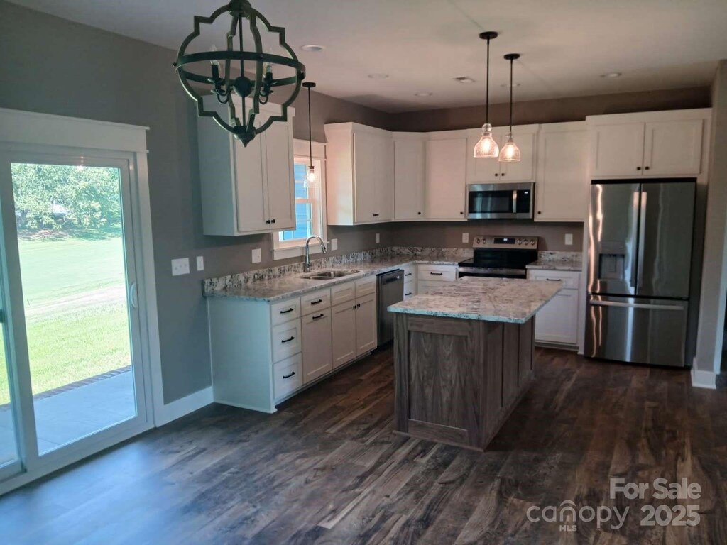 18 Morningside Dr, Granite Falls, NC 28630 - kitchen with appliances with stainless steel finishes, white cabinets, a sink, light stone countertops, and dark wood-type flooring