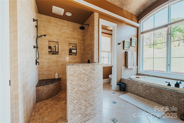 bathroom featuring healthy amount of natural light, tiled shower, toilet, and a bath