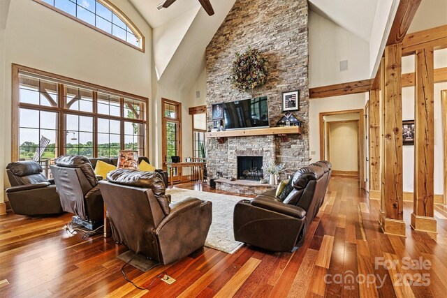 6205 Plantation Pointe Dr, Granite Falls, NC 28630 - living room featuring high vaulted ceiling, a ceiling fan, wood-type flooring, a stone fireplace, and baseboards