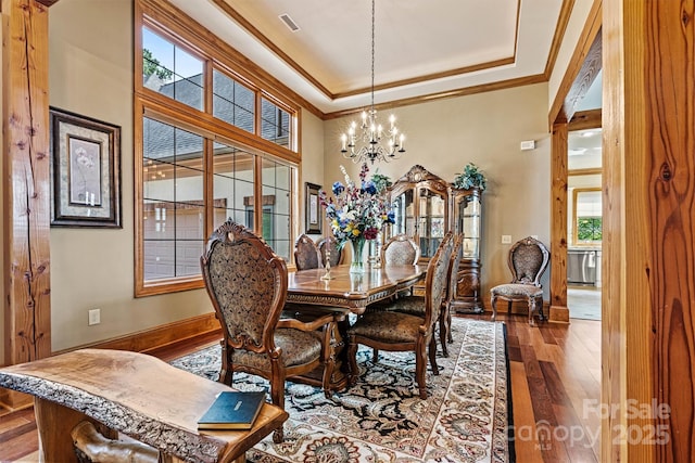 6205 Plantation Pointe Dr, Granite Falls, NC 28630 - dining area featuring a chandelier, crown molding, wood-type flooring, a tray ceiling, and baseboards