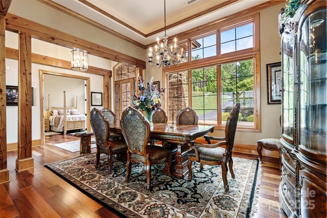 6205 Plantation Pointe Dr, Granite Falls, NC 28630 - dining area with a chandelier, crown molding, baseboards, wood-type flooring, and plenty of natural light