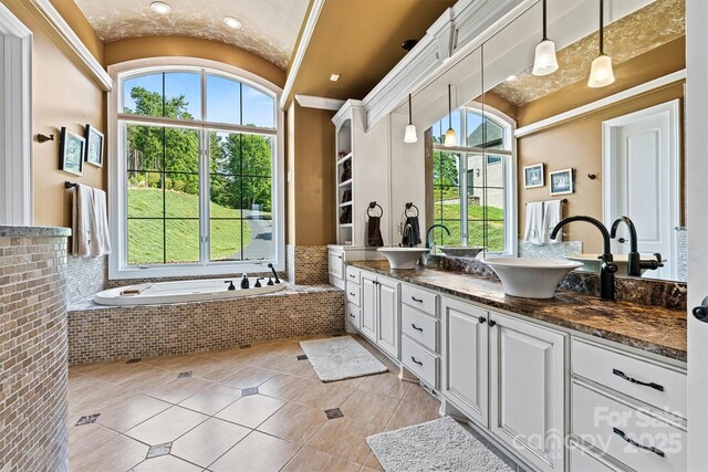 6205 Plantation Pointe Dr, Granite Falls, NC 28630 - bathroom featuring double vanity, healthy amount of natural light, tile patterned flooring, a garden tub, and lofted ceiling