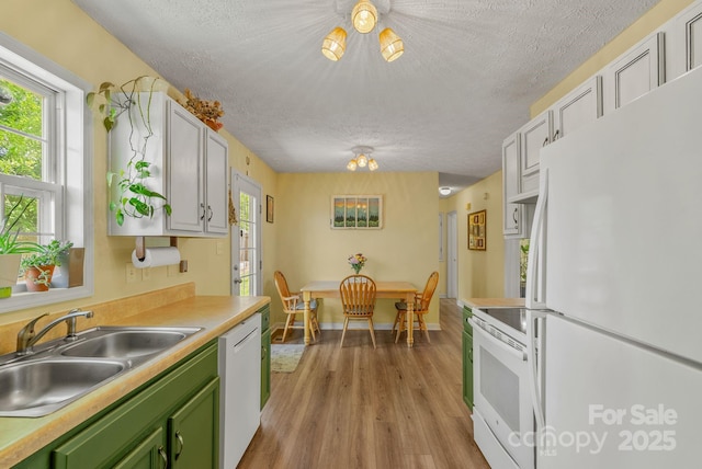 11 Louisville Pl, Asheville, NC 28806 - kitchen featuring white appliances, a sink, green cabinetry, a textured ceiling, and light wood finished floors