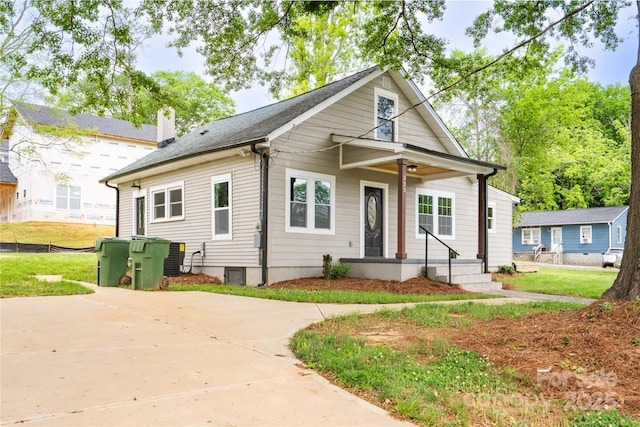 225 N Lee St, Mount Holly, NC 28120 - view of front facade featuring covered porch, a chimney, and central AC