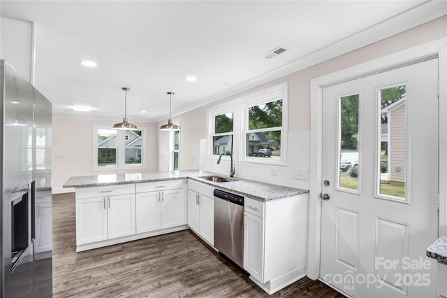 225 N Lee St, Mount Holly, NC 28120 - kitchen featuring appliances with stainless steel finishes, a sink, light stone countertops, white cabinetry, and a peninsula