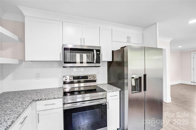 225 N Lee St, Mount Holly, NC 28120 - kitchen with stainless steel appliances, white cabinetry, light stone counters, light wood finished floors, and recessed lighting