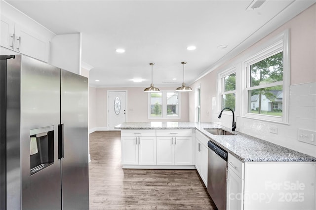 225 N Lee St, Mount Holly, NC 28120 - kitchen with stainless steel appliances, a sink, white cabinetry, dark wood-style floors, and ornamental molding