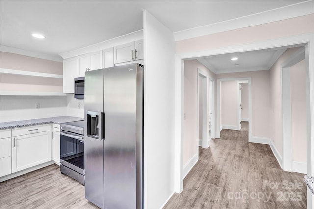 225 N Lee St, Mount Holly, NC 28120 - kitchen featuring appliances with stainless steel finishes, open shelves, white cabinetry, light wood finished floors, and baseboards