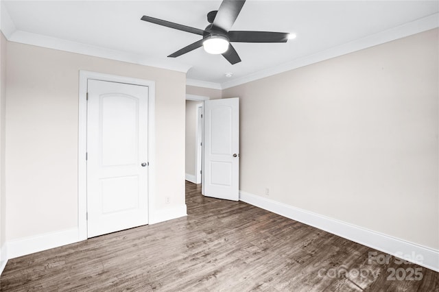 225 N Lee St, Mount Holly, NC 28120 - unfurnished bedroom with wood finished floors, ornamental molding, baseboards, and a ceiling fan