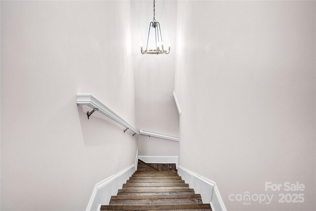 225 N Lee St, Mount Holly, NC 28120 - stairway with a chandelier, baseboards, and wood finished floors