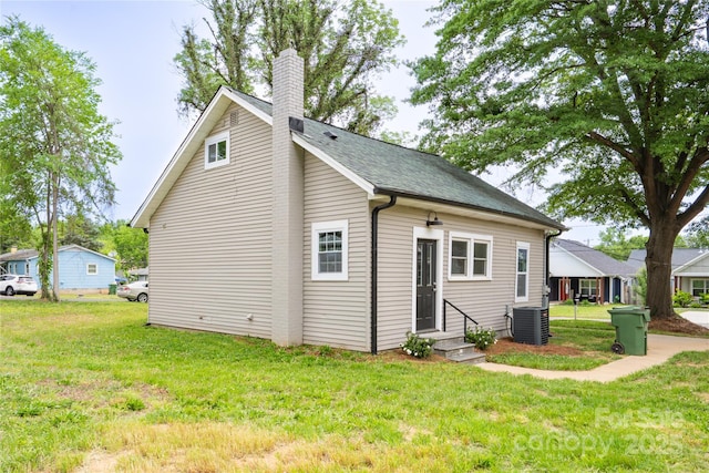 225 N Lee St, Mount Holly, NC 28120 - rear view of property with a yard, entry steps, central air condition unit, and a chimney