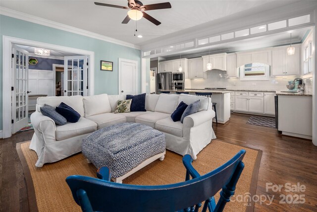living area featuring crown molding, dark wood-type flooring, a ceiling fan, french doors, and recessed lighting