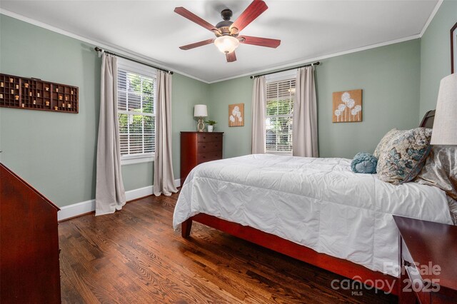 bedroom featuring baseboards, wood finished floors, crown molding, and a ceiling fan
