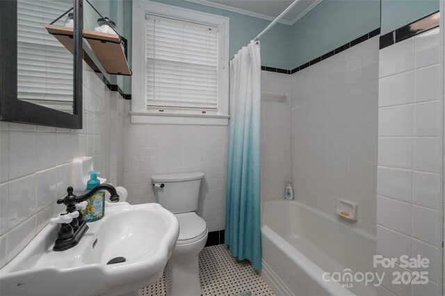 full bath featuring ornamental molding, toilet, shower / tub combo, a sink, and tile walls