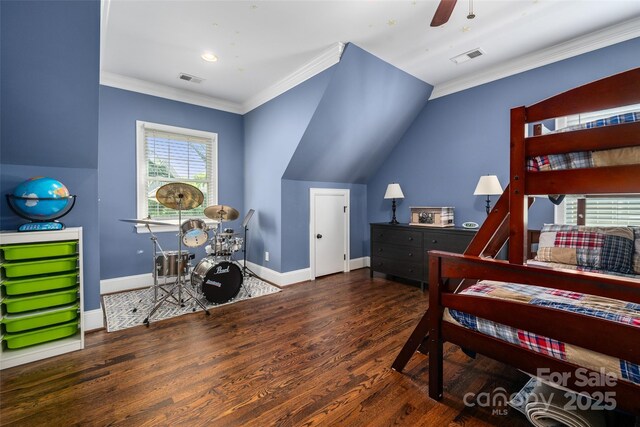 bedroom with crown molding, wood finished floors, and baseboards
