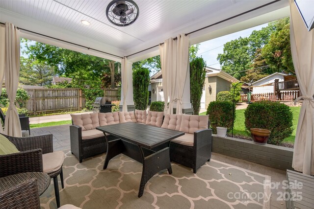 sunroom featuring outdoor dining area