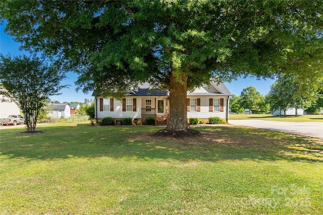 view of front of property with a front yard and concrete driveway