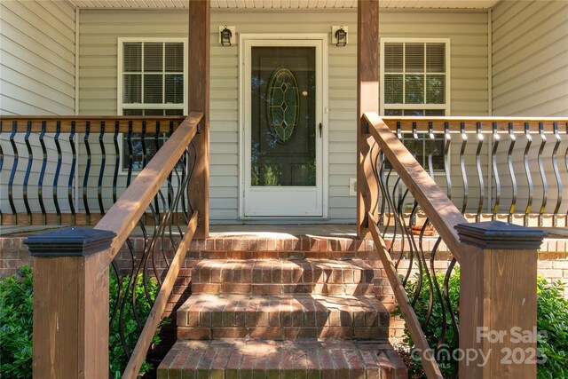 doorway to property featuring covered porch