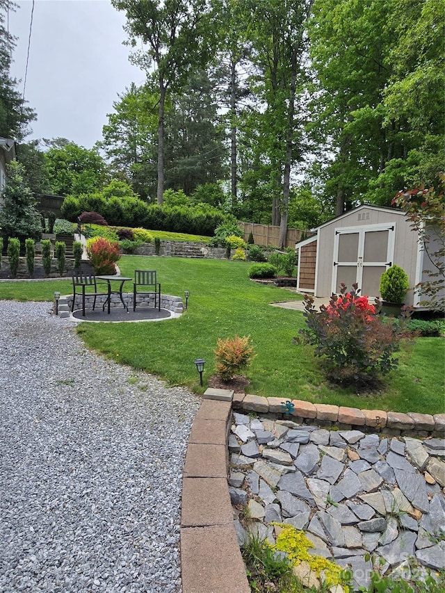 view of yard featuring a shed and an outbuilding